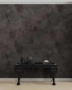 a black table sitting in front of a wall with vases on top of it