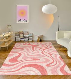 a living room with a pink rug on the floor next to a white chair and table