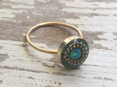 "Stunning gold opal ring. Unique mint green boho ring. Bohemian filled ring for women. Unique gold opal ring with a breezy mint green background. Trendy, fashionable design. This opal ring will keep your look feminine and delicate. Great for everyday wear, and will be a gorgeous, sparkly addition to an evening dress. The ring will make a beautiful gift to any women of any age! This boho ring is Hilawelner original design. Made of gold filled, polymer inlaid with opal stone and finished with enam Green Bohemian Crystal Ring, Bohemian Green Crystal Round Ring, Bohemian Green Opal Ring, Bohemian Adjustable Opal Ring, Bohemian Opal Ring, Bohemian Opal Handmade Rings, Green Bohemian Opal Ring, Handmade Opal Rings In Bohemian Style, Bohemian Gold Opal Ring