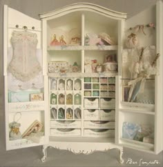 an open white cabinet filled with lots of items