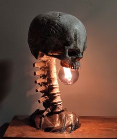 a light that is on top of a table next to a skull head and bones