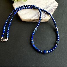 Unisex Handmade Beaded Necklace Made With Highest Quality Royal Blue Lapis Lazuli 4mm Round Beads And 5mm Faceted Cut Beads. * Gemstone: Lapis Lazuli Round Beads. * Bead Size: 4mm Round And 5mm Faceted Cut * Metal: Stainless Steel * Necklace Length: 22” Inches . ~ Lapis Lazuli Is September Birthstone * Lapis Lazuli Is One Of The Most Mystical Gemstones Out There. Known As A Stone Of Wisdom, This Gold And Blue Gem Can Help You To Tap Into Your Inner Intuition And To Clear Any Blockages From Your Boys Beaded Necklace, Cross Choker Necklace, Black Diamond Pendant, Blue Gemstone Necklace, Mens Beaded Necklaces, Cross Choker, Lapis Lazuli Beads, Handmade Beaded Necklaces, Braided Leather Bracelet