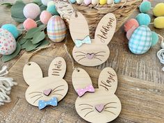 wooden easter bunnies with personalized bunny ears and bow ties are on the table