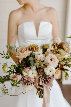 a bride holding a bouquet of flowers in her hands