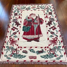 a red and white quilt with an image of a woman holding a child on it