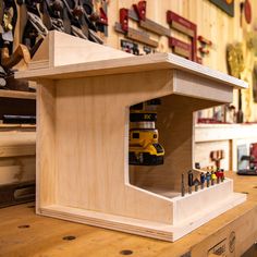 a workbench made out of plywood and wood with tools in the background