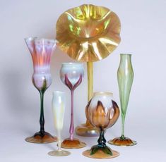 several different colored glass vases sitting next to each other