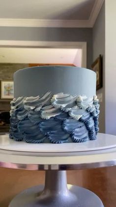 a blue and white cake sitting on top of a table