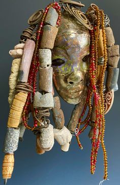 a woman's head is adorned with beads and other items that are attached to it