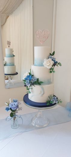 Blue, roses, poppies, hydrangea , sea thistle  all in sugar.  Marbling, watercolour tall and elegant Dusty Blue Simple Wedding Cake, Wedding Cake Designs 2 Tier Blue, 2 Tier Elegant Wedding Cake, Simple Dusty Blue Wedding Cake, 3 Tier Wedding Cake Dusty Blue, Watercolour Wedding Cake, Wedding Cake 2 Tier Blue, Ube Wedding Cake, White Blue Wedding Cake