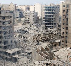 an old city with lots of rubble and broken buildings in the foreground is shown