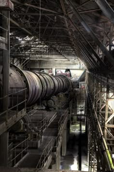 an industrial area with pipes and machinery in the center, including large tanks on either side