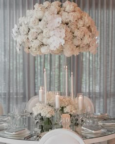 a table with flowers and candles on it