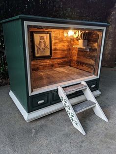 an old fashioned television set with its door open and steps up to the tv screen