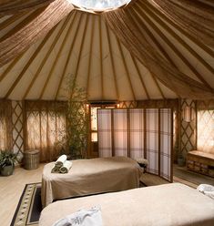 the inside of a yurt with a large bed in it