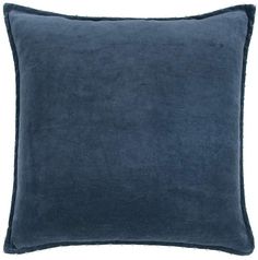 a blue velvet pillow on a white background