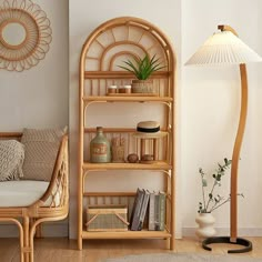 a living room with a lamp, bookshelf and wicker furniture in it