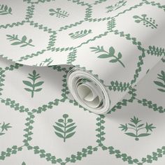 a green and white wallpaper with leaves on it