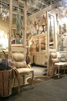 an old fashion store with chairs and mirrors