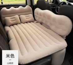 an inflatable car seat with two pillows on the front and rear seats folded down