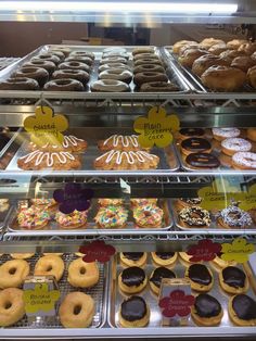 a display case filled with lots of different types of doughnuts and pastries