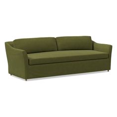 a green couch sitting on top of a white floor