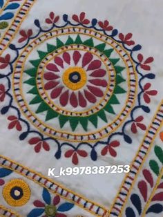 an embroidered table cloth with colorful designs on the top and bottom, in various colors