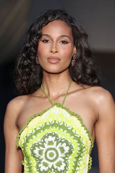 a model wearing a green and yellow dress