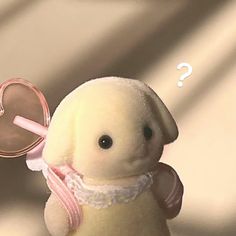 a stuffed animal holding a heart shaped object