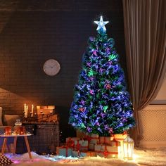 a brightly lit christmas tree in the corner of a living room with presents on the floor