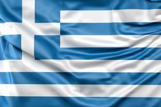 the flag of greece is waving in the wind