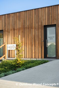 a wooden building with a sign in front of it