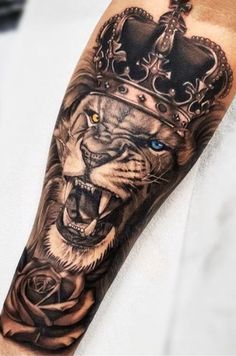 a lion with a crown on his head and blue eyes is shown in this tattoo