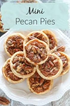 small pecan pies on a white plate with fork and napkin in the background