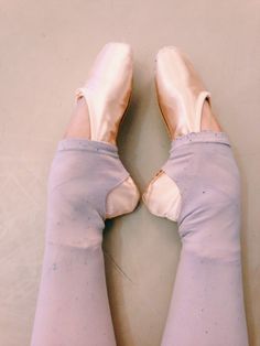 a pair of ballet shoes that have been worn by someone with their feet in the air