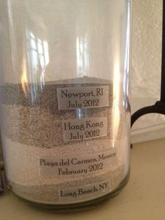 a jar filled with lots of sand on top of a counter