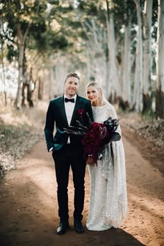 a man and woman standing on a dirt road in front of trees with the words hello may above them