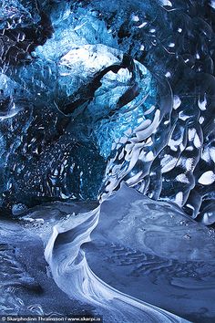 an ice cave with water flowing down it