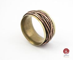 The ring is hand-made in Italy by solid brass* sheet and copper wire, with fire, hammer, and welding. The copper part can freely rotating around the band. There is just one sample made from this design which makes it one of a kind. (You will receive the same ring in the image.) Size: 8½ - 8¾   /   Inside diameter: 19.2mm Width: 11 mm / Thickness: 3 mm Shipping is free for everywhere by registered Italian post. (10-30 days) There is also available Express shipping (Delivery in 2 - 5 days), you can choose it during check out. Prices for update to express shipping: USA           $19 Canada     $25 Everywhere else  $60 (La spedizione per l"Italia è espressa e gratuita.) *Solid Brass: is 85% copper and 15% zinc. If your skin has a tendency to turn green from copper, these rings may have the sam Rotating Ring, Brass Sheet, Brass And Copper, Copper Ring, Copper Rings, Copper And Brass, Brass Ring, Copper Wire, Solid Brass