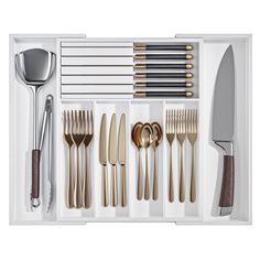 an assortment of silverware and utensils in a white box on a white background