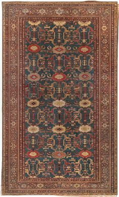 an antique persian rug with various colors and patterns