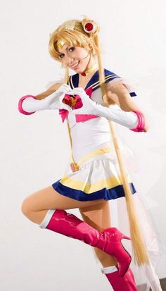 a woman with long blonde hair and pink boots is posing for the camera while holding a pole