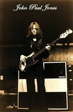 john paul jones playing an electric guitar on stage