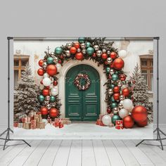 an outdoor christmas scene with decorations and presents on the ground in front of a green door