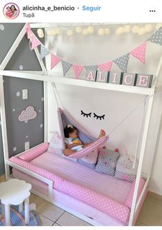 a child's bed with a pink and white canopy