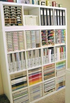 a white book shelf filled with lots of books