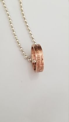 A handmade coin ring necklace made from a US Copper Penny. It has a natural Copper patinas and is coated with a clear sealant to maintain the current finish. It Is hanging on an 16-20 Inch  Sterling Silver Plated Chain. What a great way to celebrate one's Birthday, Anniversary or any  other special occasion with this handcrafted Double sided Coin Ring  made from a Penny. This Ring comes with a Ball Chain Necklace. Hand Made In The USA!!Each ring will be sealed with a jewelry sealer,  which helps Nickel-free Jewelry For Anniversary Gift, Stamped Round Pendant Jewelry For Anniversary Gift, Stamped Jewelry With Round Pendant For Anniversary, Stamped Rose Gold Round Pendant Jewelry, Stamped Rose Gold Round Jewelry, Handmade Coin Jewelry For Anniversary, Penny Jewelry, Copper Penny, Penny Coin