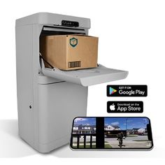 an appliance with a cardboard box on top of it next to a phone