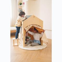 two children playing in a wooden play house