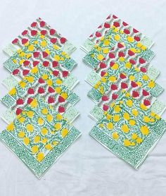 two pieces of paper with yellow and red flowers on them